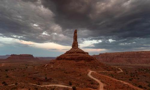 Dramatic view of sandstone tower in Valley of the Gods in Utah under stormy skies